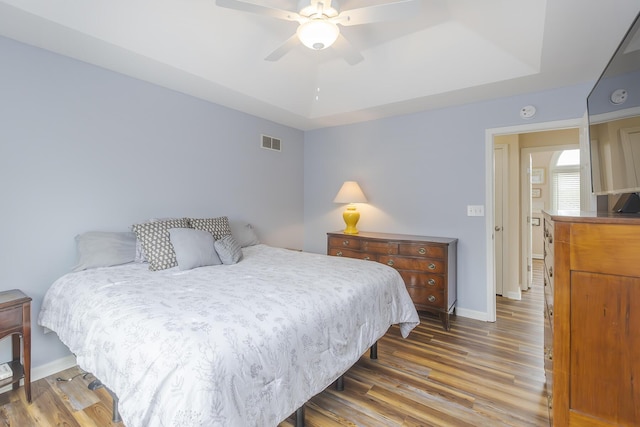1208 Four Wynds Trl, Lexington, KY 40515 - bedroom featuring a tray ceiling, wood finished floors, baseboards, and a ceiling fan