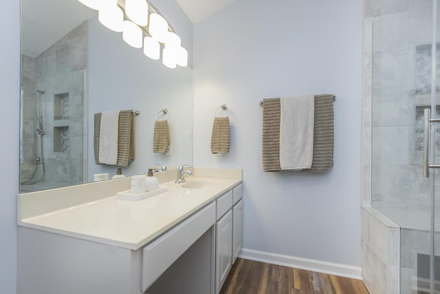 1208 Four Wynds Trl, Lexington, KY 40515 - bathroom with wood finished floors, tiled shower, baseboards, vanity, and lofted ceiling