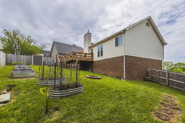 1208 Four Wynds Trl, Lexington, KY 40515 - back of house with brick siding, a shed, a deck, a chimney, and an outdoor structure