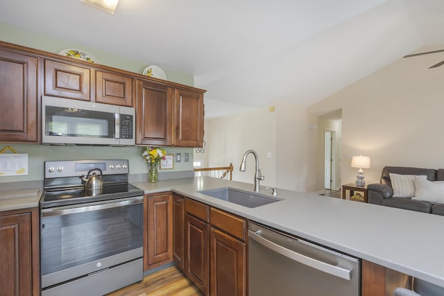 1208 Four Wynds Trl, Lexington, KY 40515 - kitchen with appliances with stainless steel finishes, a sink, light countertops, open floor plan, and lofted ceiling