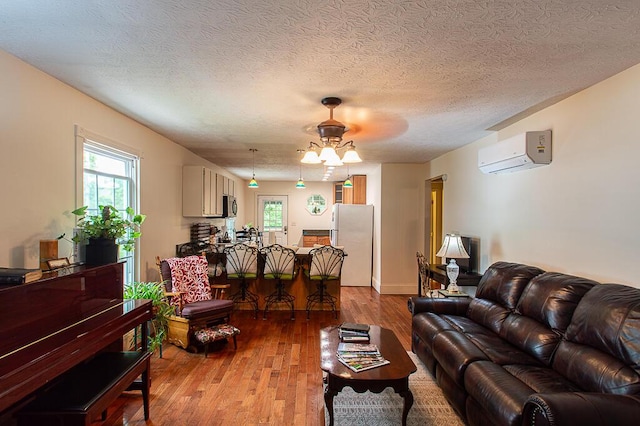 121 Meredith Ave, Frankfort, KY 40601 - living room featuring a wall unit AC, ceiling fan, wood-type flooring, and a textured ceiling