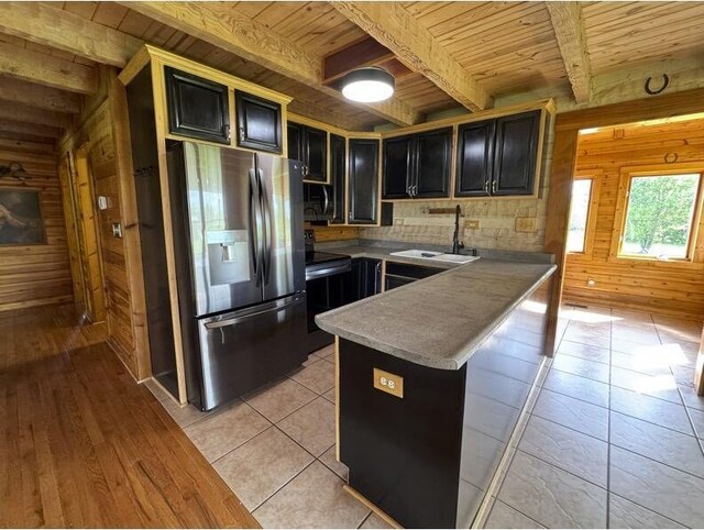 792 Tuggle Rd, Lancaster, KY 40444 - kitchen with stainless steel fridge with ice dispenser, wooden ceiling, wooden walls, a sink, and a peninsula