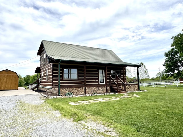 792 Tuggle Rd, Lancaster, KY 40444 - view of front of house featuring metal roof, gravel driveway, an outdoor structure, and covered porch