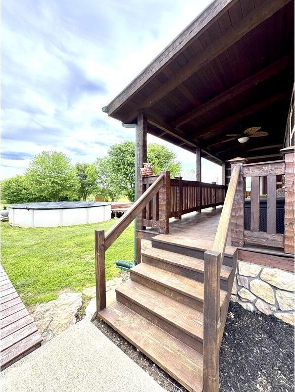 792 Tuggle Rd, Lancaster, KY 40444 - deck featuring an outdoor pool, a lawn, and a ceiling fan