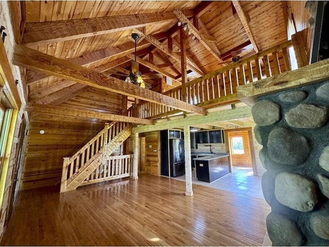 792 Tuggle Rd, Lancaster, KY 40444 - unfurnished living room featuring stairs, wood ceiling, wood finished floors, high vaulted ceiling, and a sink