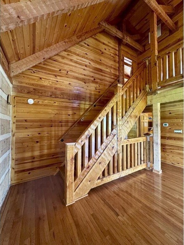 792 Tuggle Rd, Lancaster, KY 40444 - additional living space featuring wood walls, wood ceiling, hardwood / wood-style floors, and stairs