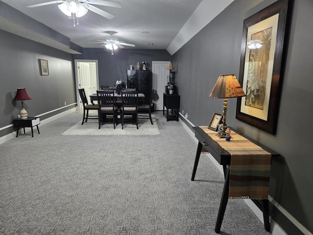 dining room featuring carpet, baseboards, and a ceiling fan
