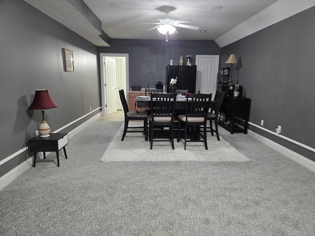 dining space featuring a ceiling fan, baseboards, and carpet