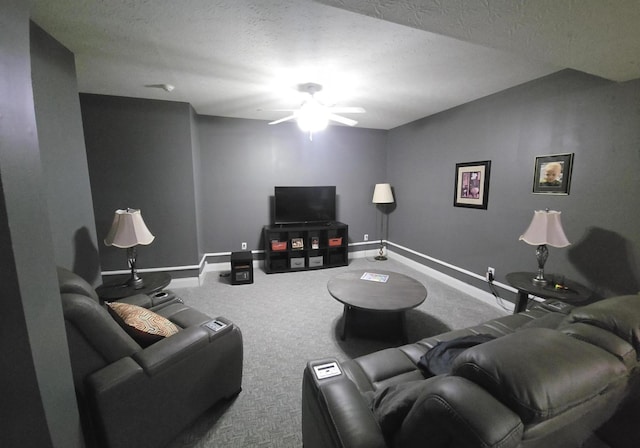 living room with a textured ceiling, carpet, baseboards, and a ceiling fan