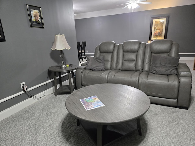carpeted living room featuring baseboards and ceiling fan