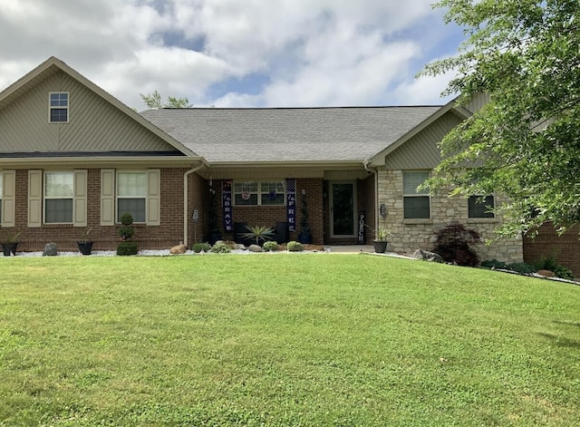 single story home with a front lawn, brick siding, roof with shingles, and stone siding