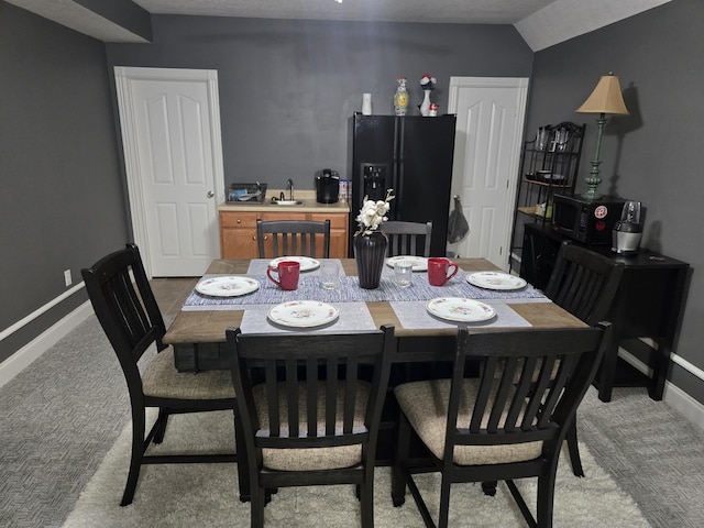 dining space with light colored carpet and baseboards