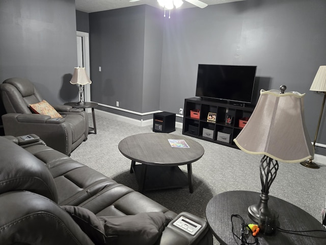living room with a ceiling fan, baseboards, and carpet floors