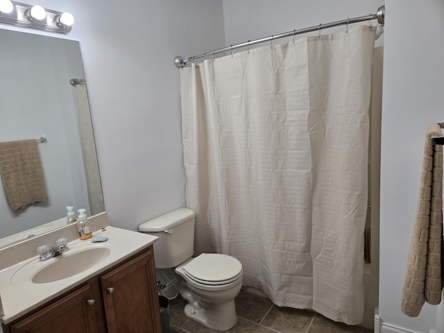 bathroom with toilet, tile patterned flooring, and vanity