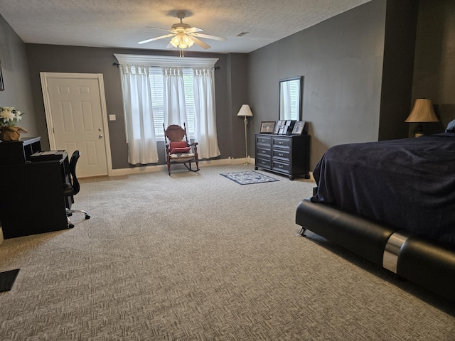bedroom featuring carpet, baseboards, a ceiling fan, and a textured ceiling