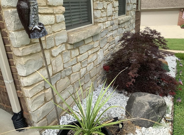 details with concrete driveway and stone siding