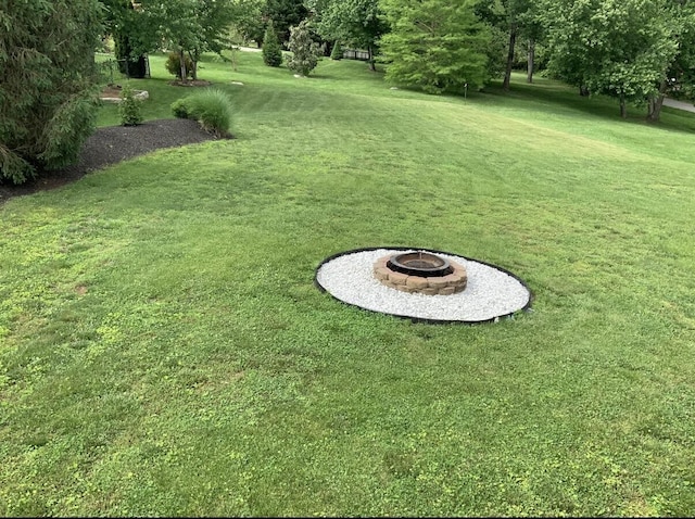view of yard with a fire pit