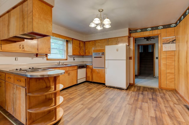 kitchen with white appliances, a sink, stainless steel counters, open shelves, and light wood-type flooring