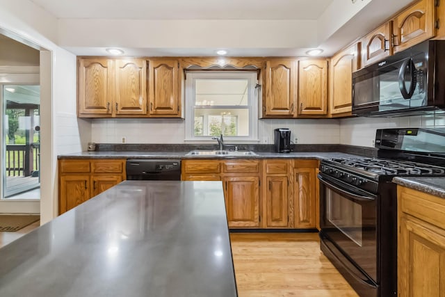 1141 Danville Rd, Lancaster, KY 40444 - kitchen with a sink, dark countertops, black appliances, and brown cabinets