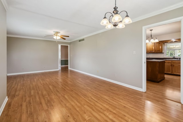 1141 Danville Rd, Lancaster, KY 40444 - unfurnished room featuring light wood-style flooring, ceiling fan with notable chandelier, crown molding, visible vents, and baseboards