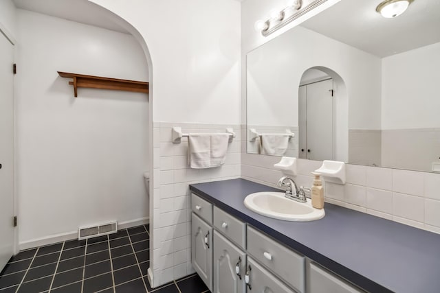 1141 Danville Rd, Lancaster, KY 40444 - bathroom with tile patterned floors, vanity, visible vents, and a wainscoted wall
