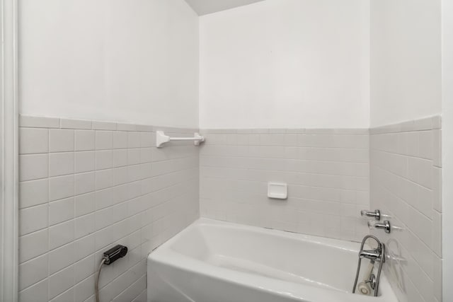 1141 Danville Rd, Lancaster, KY 40444 - bathroom featuring a wainscoted wall, tile walls, and a washtub