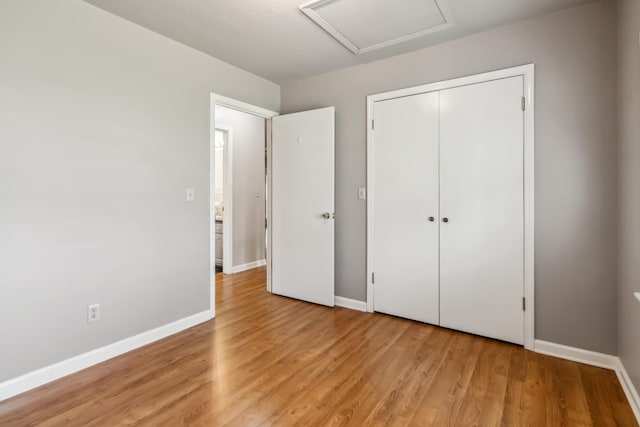 1141 Danville Rd, Lancaster, KY 40444 - unfurnished bedroom featuring light wood finished floors, attic access, and baseboards