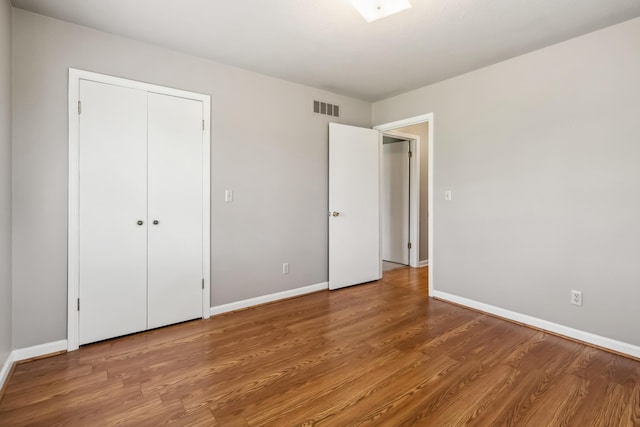 1141 Danville Rd, Lancaster, KY 40444 - unfurnished bedroom with baseboards, a closet, visible vents, and wood finished floors
