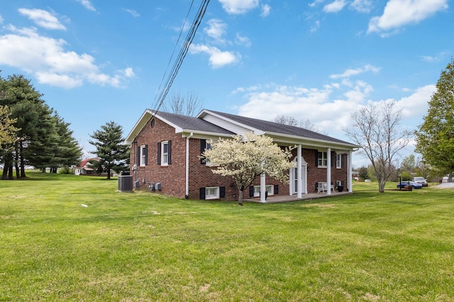 1141 Danville Rd, Lancaster, KY 40444 - view of property exterior featuring cooling unit, a yard, and brick siding
