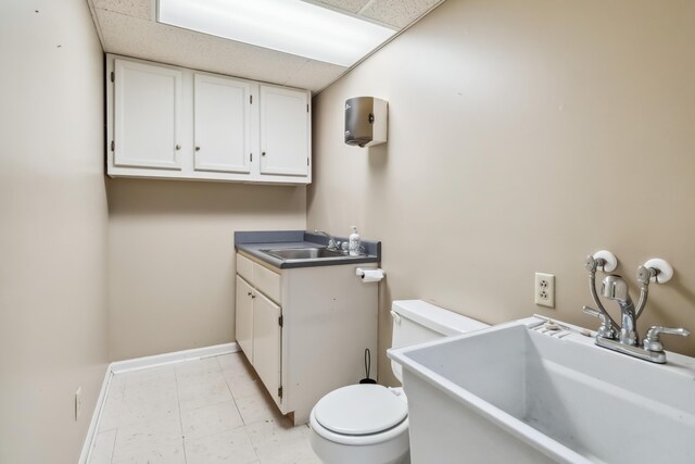 1141 Danville Rd, Lancaster, KY 40444 - half bathroom with vanity, toilet, baseboards, and a drop ceiling