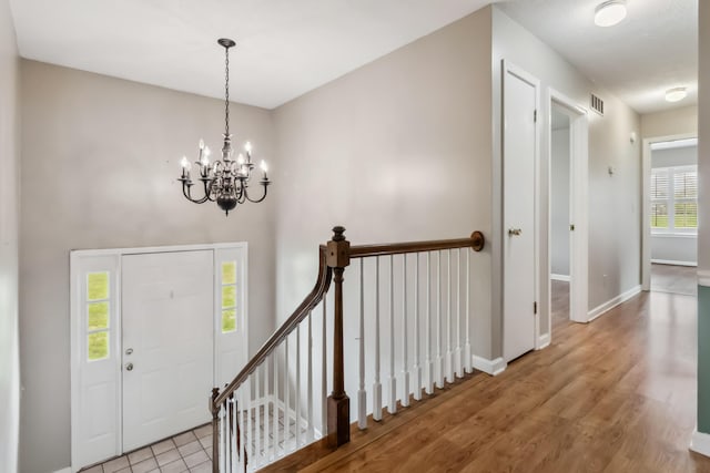 1141 Danville Rd, Lancaster, KY 40444 - foyer entrance featuring an inviting chandelier, wood finished floors, visible vents, and baseboards