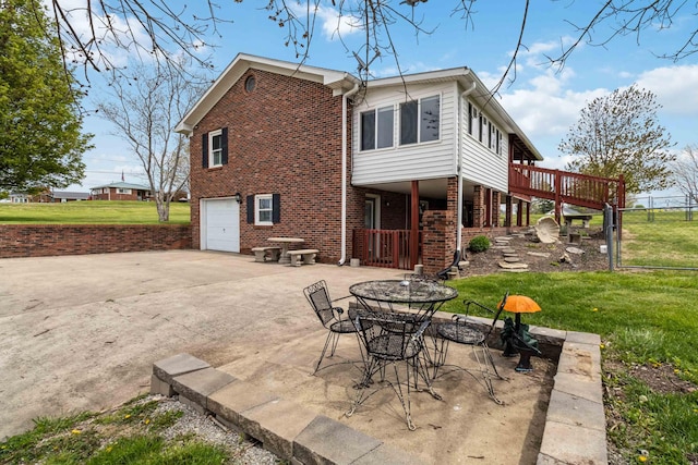 1141 Danville Rd, Lancaster, KY 40444 - back of property featuring fence, brick siding, driveway, a garage, and a lawn