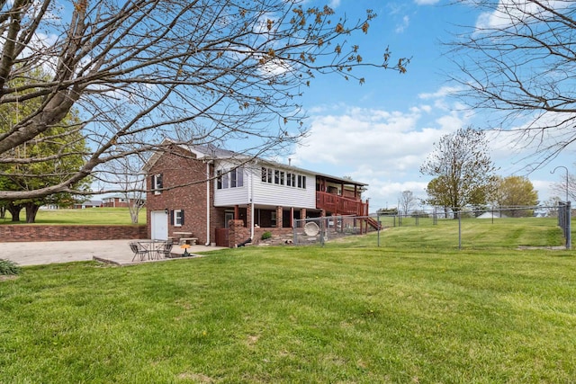 1141 Danville Rd, Lancaster, KY 40444 - rear view of house with a garage, fence, a lawn, concrete driveway, and brick siding
