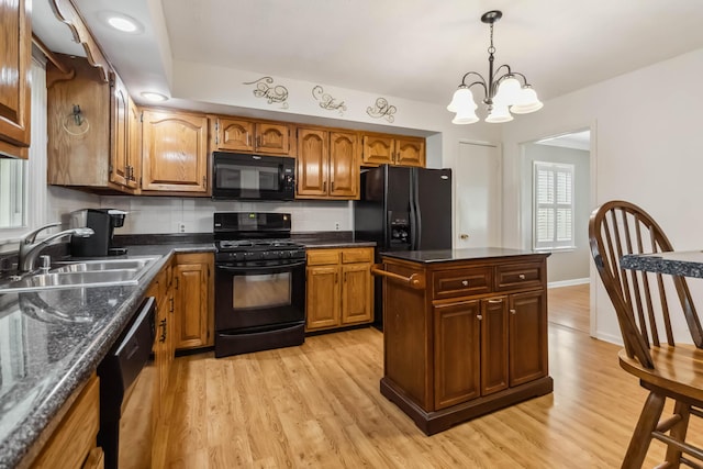 1141 Danville Rd, Lancaster, KY 40444 - kitchen featuring a sink, brown cabinets, black appliances, and light wood-style floors