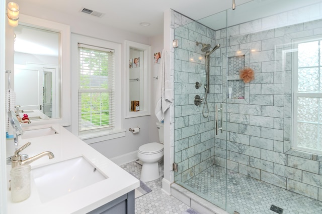 full bath with a shower stall, double vanity, toilet, baseboards, and tile patterned flooring