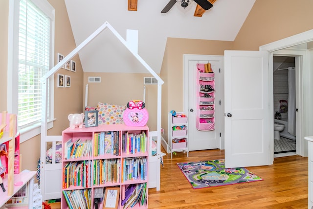game room featuring lofted ceiling, a ceiling fan, and wood finished floors