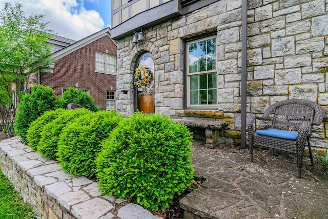 property entrance with stone siding