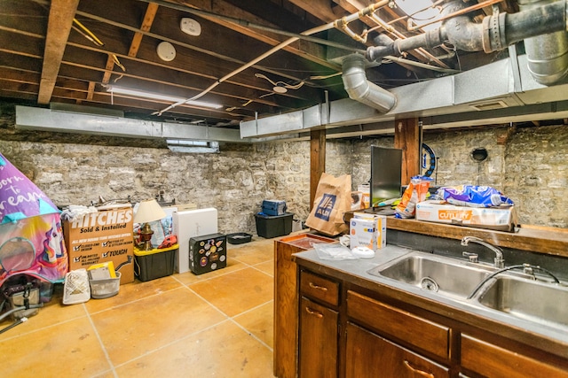 unfinished basement with a sink and tile patterned floors