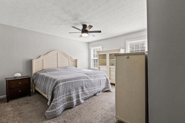 carpeted bedroom with ceiling fan and a textured ceiling