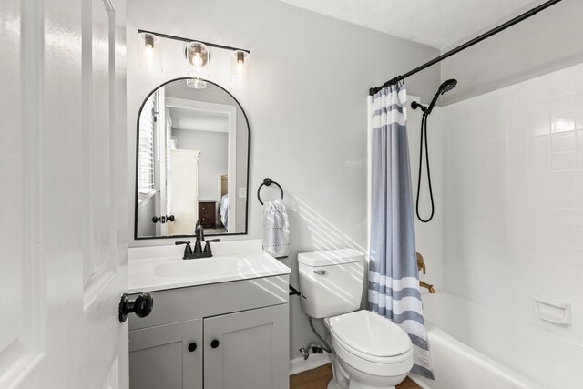 bathroom featuring toilet, vanity, and shower / bath combo with shower curtain