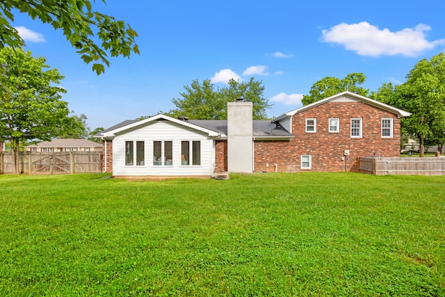 rear view of property with brick siding, a chimney, and roof with shingles