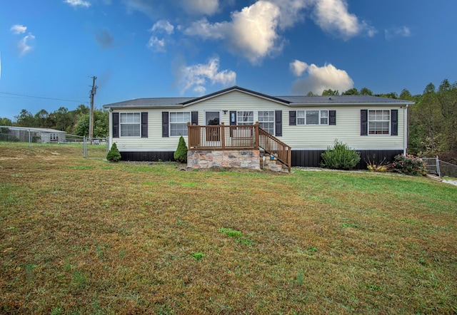 787 Wise Owl Rd, Keavy, KY 40737 - manufactured / mobile home featuring metal roof, fence, a wooden deck, and a front yard