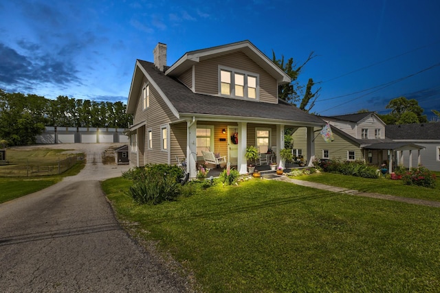 523 W High St, Mt Sterling, KY 40353 - bungalow-style home with a porch, a chimney, a front lawn, and a shingled roof