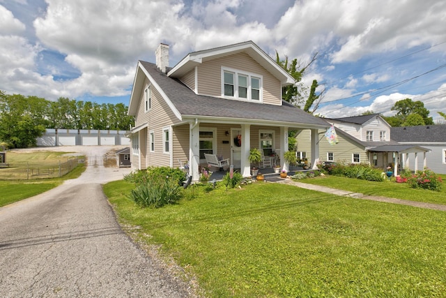 523 W High St, Mt Sterling, KY 40353 - bungalow-style house with covered porch, a chimney, a front lawn, and roof with shingles