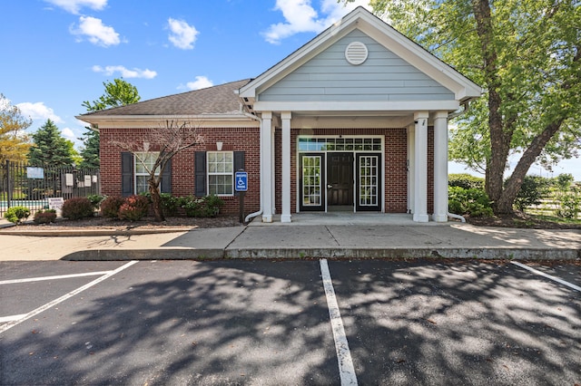 view of property featuring uncovered parking and fence