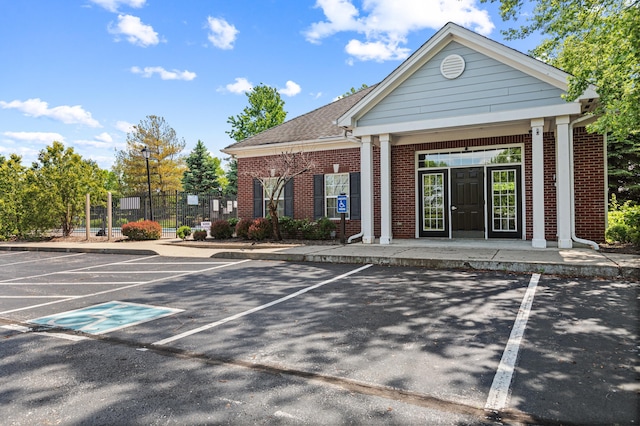 view of property with uncovered parking and fence
