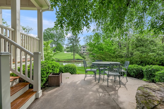1775 Mooreland Dr, Lexington, KY 40502 - view of patio / terrace with outdoor dining area, a water view, and stairway