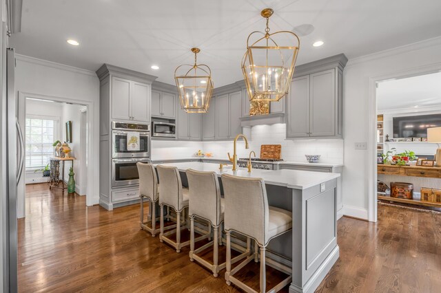 1775 Mooreland Dr, Lexington, KY 40502 - kitchen with gray cabinetry, stainless steel appliances, a chandelier, light countertops, and crown molding