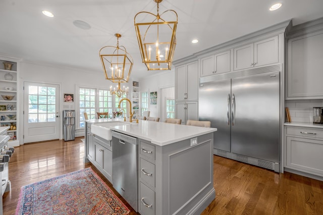 1775 Mooreland Dr, Lexington, KY 40502 - kitchen with appliances with stainless steel finishes, gray cabinets, a sink, a chandelier, and ornamental molding