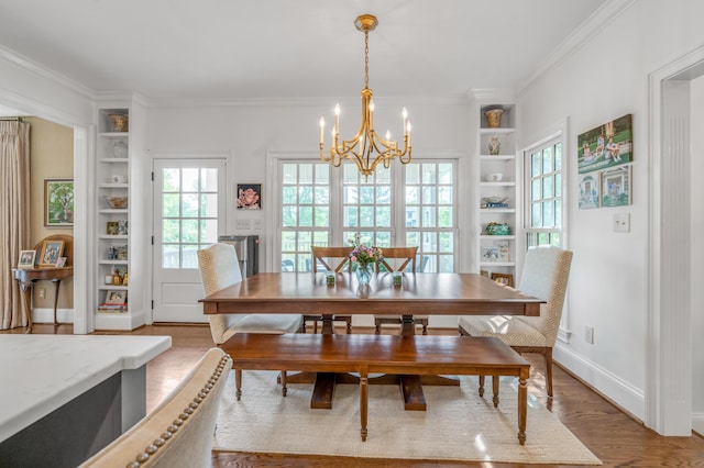 1775 Mooreland Dr, Lexington, KY 40502 - dining area with built in shelves, a chandelier, crown molding, light wood finished floors, and baseboards